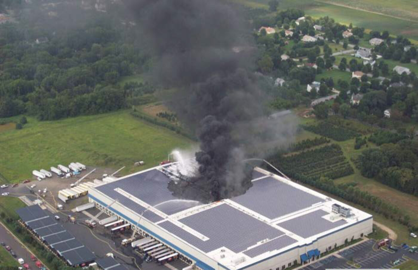 Aerial view of a distribution center fire with heavy smoke